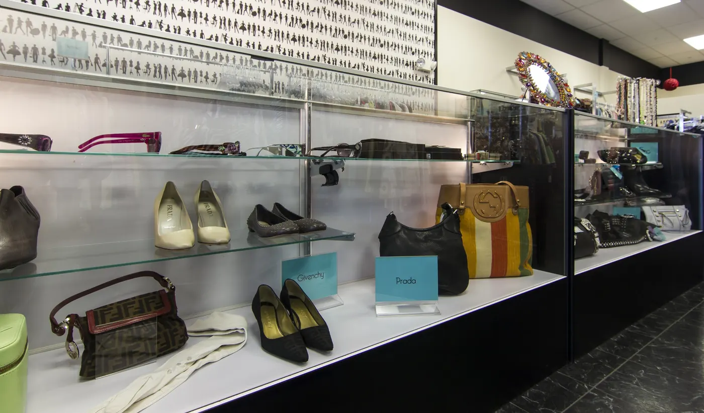 Shoes and handbags in a lit display wall